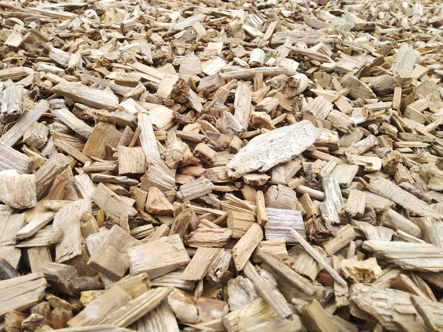 A dense pile of reclaimed wood chips and timber offcuts — the raw fibre that is compression-moulded into presswood pallets.